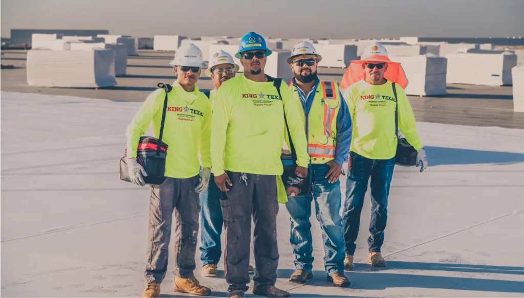King of Texas commercial roofing contractor crew standing on a large data center roof