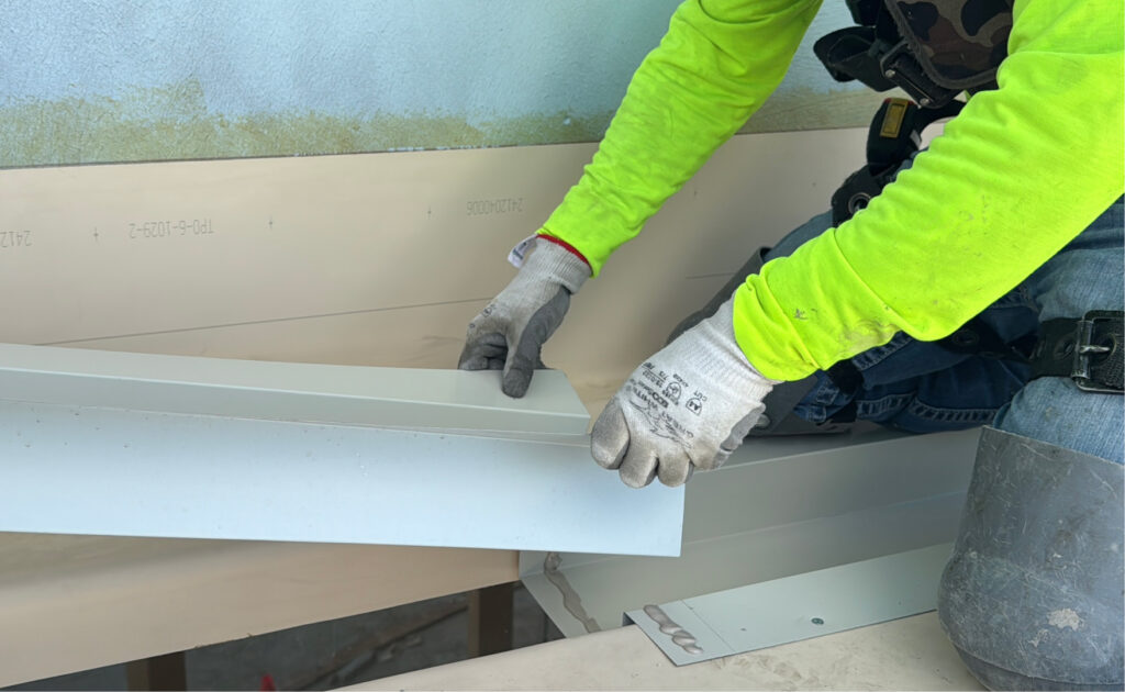 King of Texas technician installing metal edge flashing as part of roof repair.