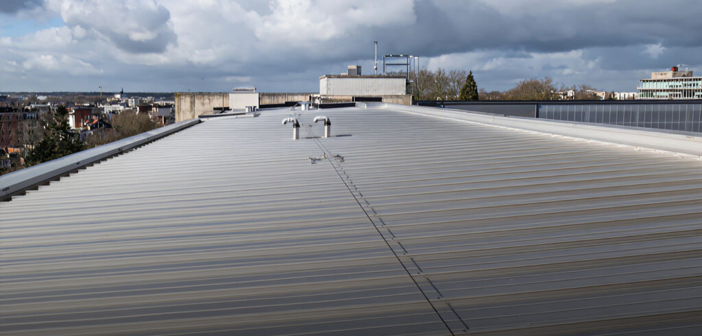 Aerial view of multi-building commercial office complex with flat roofing systems.