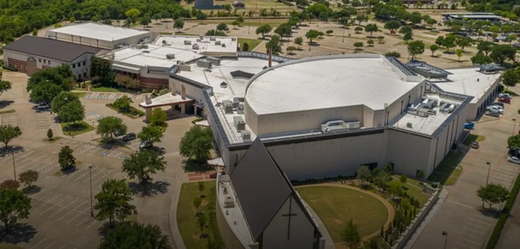 Aerial view of educational facility with large flat roof system and rooftop equipment.