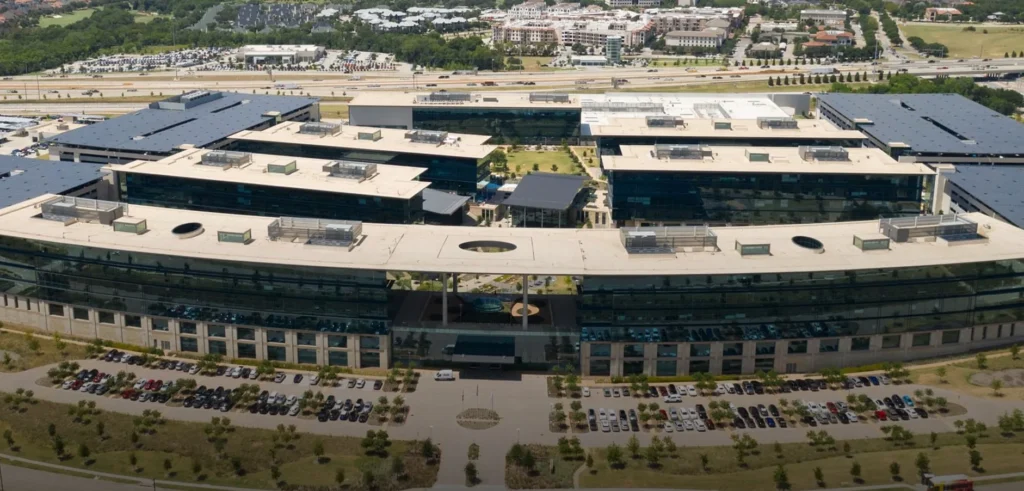 Aerial view of large multi-building office campus with flat roofing systems installed by a commercial roofing contractor.