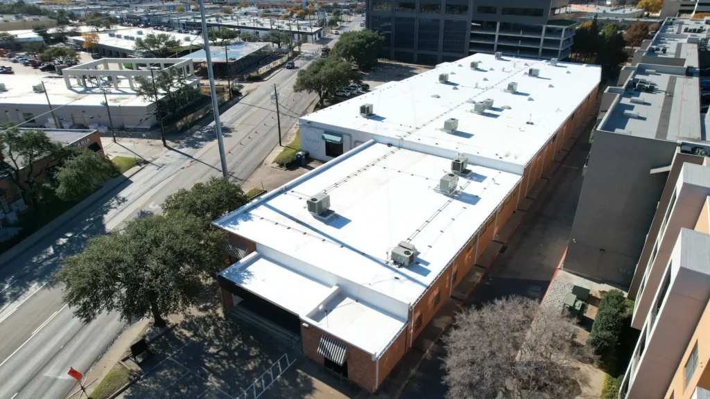 Commercial roofing contractor installing flat roof on educational facility